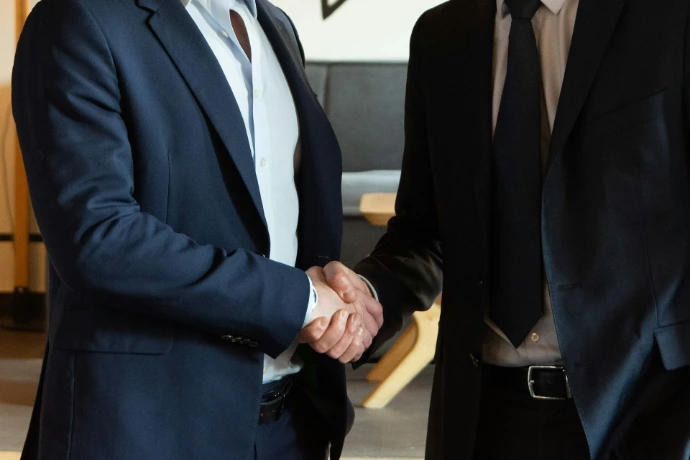 Two business partners shaking hands in agreement